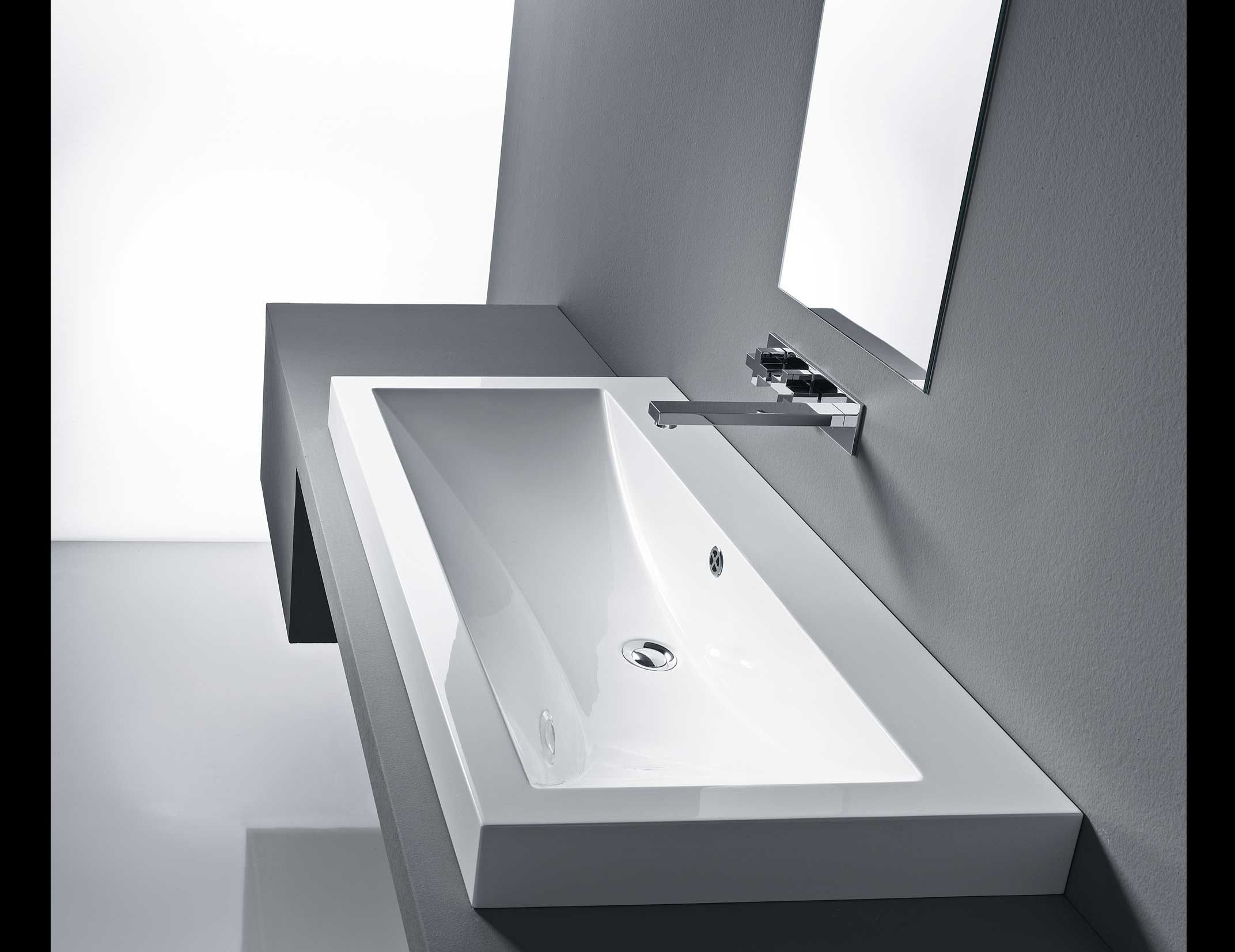 Rectangular white ceramic bathroom sink with chrome faucet